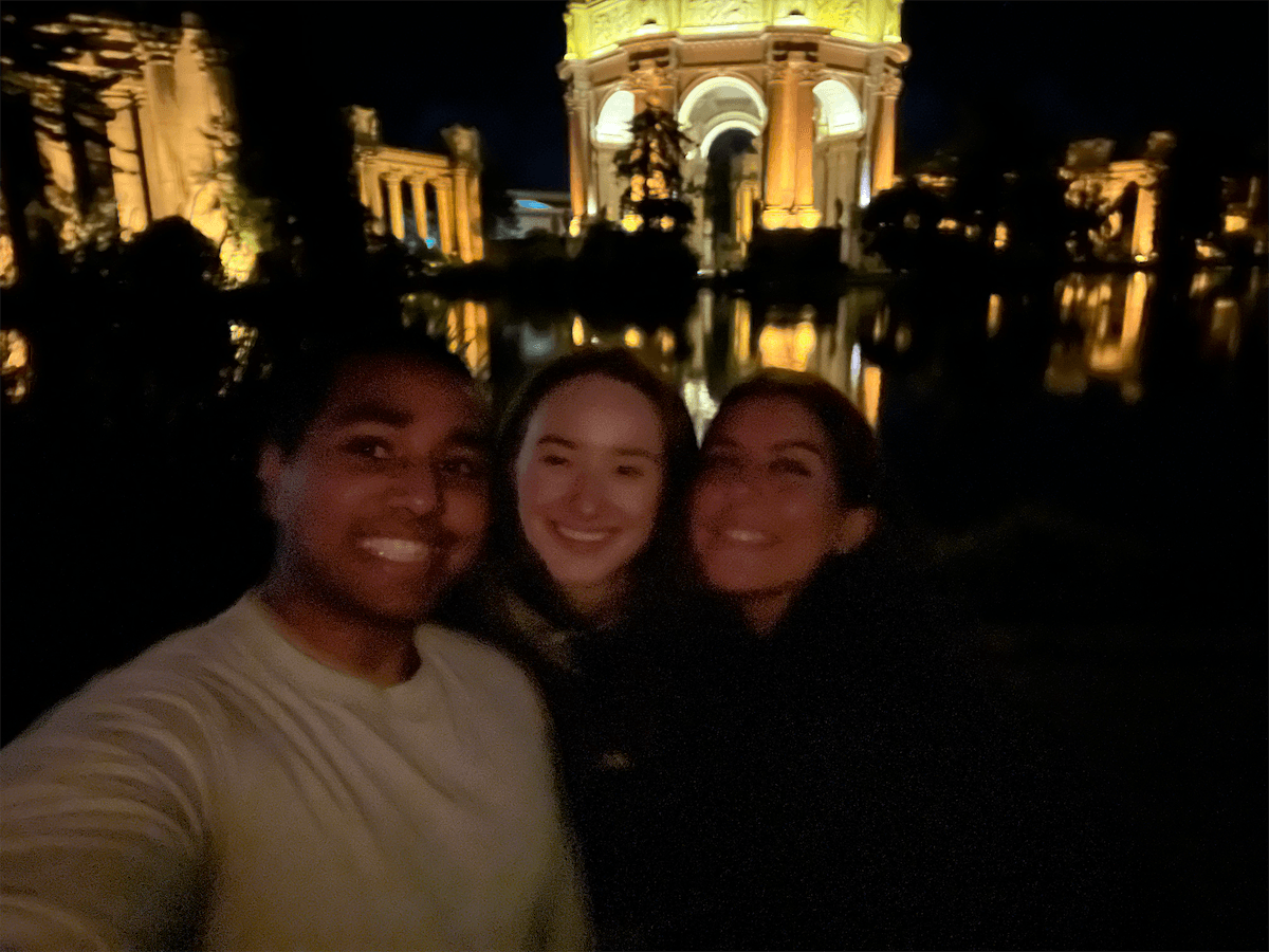 Friends together at the Palace of Fine Arts at night